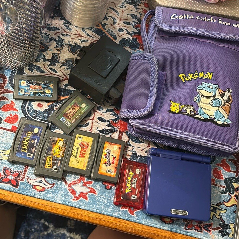 Nintendo game boy advanced SP with games and charger and Pokémon case
